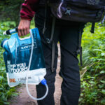 Person easily carrying a Sawyer water filter and bag